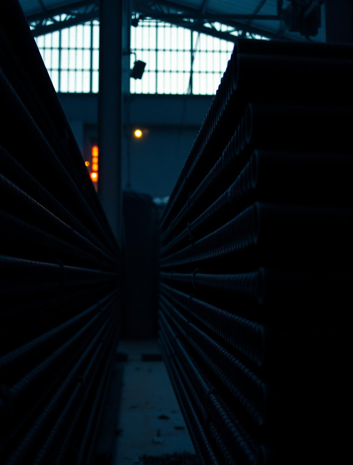 Stacked steel rebars in an industrial warehouse